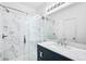 Modern bathroom with marble-look shower enclosure, sleek vanity, and contemporary fixtures at 5571 Killarney St, Denver, CO 80249