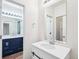 Stylish bathroom featuring a marble-look vanity, modern mirror, and contemporary design at 5571 Killarney St, Denver, CO 80249