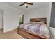 Cozy bedroom with a wooden bed frame and plush bedding, next to the ensuite bathroom at 5571 Killarney St, Denver, CO 80249