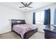 Cozy bedroom with a ceiling fan, plush carpet, and a comfortable bed frame at 5571 Killarney St, Denver, CO 80249