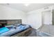 Bedroom with nice headboard with shelves, drawers under bed, and window with curtains at 5571 Killarney St, Denver, CO 80249