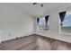 Bright bedroom with neutral walls, hardwood floors, large window, and modern design at 5571 Killarney St, Denver, CO 80249