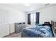 Bedroom with nice headboard with shelves, drawers under bed, and window with curtains at 5571 Killarney St, Denver, CO 80249