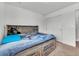 Bedroom with storage under bed and closet at 5571 Killarney St, Denver, CO 80249