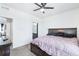Relaxing bedroom with carpet, ceiling fan, and access to the bathroom at 5571 Killarney St, Denver, CO 80249