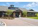 View of the community clubhouse with well-manicured landscaping at 5571 Killarney St, Denver, CO 80249