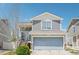 Home exterior showing the garage, front entrance, and blue and gray siding at 5571 Killarney St, Denver, CO 80249