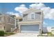 Charming two-story home with a two-car garage and staircase leading to the front door at 5571 Killarney St, Denver, CO 80249