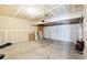 Unfinished garage with a concrete floor and white drywall at 5571 Killarney St, Denver, CO 80249