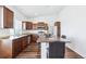 Charming kitchen with wooden cabinetry, stainless steel appliances and a spacious breakfast bar at 5571 Killarney St, Denver, CO 80249