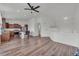 Modern eat-in kitchen featuring wood cabinets, stainless appliances, island with bar seating, and hardwood floors at 5571 Killarney St, Denver, CO 80249