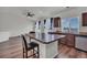 Bright kitchen area featuring an island with bar stool seating and open concept design at 5571 Killarney St, Denver, CO 80249