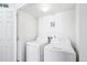 Well-lit laundry room with washer and dryer at 5571 Killarney St, Denver, CO 80249