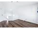 Upstairs bonus room with vaulted ceiling, wood floors, and windows for natural light at 5571 Killarney St, Denver, CO 80249