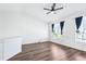 Upstairs bonus room with vaulted ceiling, wood floors, and windows for natural light at 5571 Killarney St, Denver, CO 80249