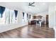 Open-concept living and kitchen area featuring wood flooring and lots of natural light at 5571 Killarney St, Denver, CO 80249