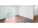 Open-concept living room with wood floors and ample natural light at 5571 Killarney St, Denver, CO 80249