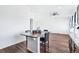 Open-concept living and kitchen area featuring wood flooring and lots of natural light at 5571 Killarney St, Denver, CO 80249