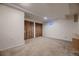 A spacious basement with carpet and a closet awaits transformation to a living space or recreation area at 2697 S Deframe Cir, Lakewood, CO 80228