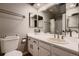 Bathroom featuring a vanity with sink, a large mirror, and a shower and bathtub combo at 2697 S Deframe Cir, Lakewood, CO 80228