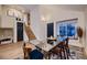 Bright dining room with a modern glass table, stylish rug, and staircase to the upper level at 2697 S Deframe Cir, Lakewood, CO 80228