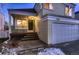 House exterior showcasing front entrance, deck, and attached garage at dusk at 2697 S Deframe Cir, Lakewood, CO 80228