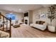 Cozy living room with modern furnishings, fireplace, hardwood floors, and a bright window at 2697 S Deframe Cir, Lakewood, CO 80228