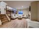 Bright living room with hardwood floors, fireplace, modern staircase and a view to the second floor at 2697 S Deframe Cir, Lakewood, CO 80228