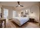 Calming main bedroom featuring a ceiling fan, accent lighting, and an en-suite bathroom at 2697 S Deframe Cir, Lakewood, CO 80228