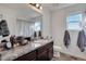 Bathroom featuring a gray countertop, a modern mirror, and plenty of natural light from the window, and neutral gray finishes at 17838 E 54 Th Ave, Denver, CO 80249