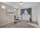 Bedroom featuring a desk, chair, artwork, and window with neighborhood views at 17838 E 54 Th Ave, Denver, CO 80249