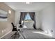 Bedroom featuring a desk, chair, and window with neighborhood views at 17838 E 54 Th Ave, Denver, CO 80249