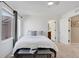 Bedroom featuring a bright window and bed with views to a bathroom at 17838 E 54 Th Ave, Denver, CO 80249
