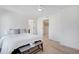 Bedroom featuring a bright window and bed with doors to two other rooms at 17838 E 54 Th Ave, Denver, CO 80249