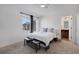 Bedroom featuring a bright window and bed with views to a bathroom with dark-stained vanity at 17838 E 54 Th Ave, Denver, CO 80249