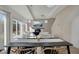 Bright dining room featuring access to living room and views from large windows at 17838 E 54 Th Ave, Denver, CO 80249