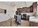 Well-designed kitchen features espresso cabinets, black appliances, and a movable island with seating at 17838 E 54 Th Ave, Denver, CO 80249