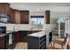 Bright kitchen features espresso cabinets, stainless steel appliances, and access to outdoor space at 17838 E 54 Th Ave, Denver, CO 80249