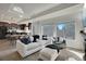 Bright open-concept living room featuring sleek furniture, and large windows at 17838 E 54 Th Ave, Denver, CO 80249
