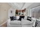 Bright living room showcases a comfortable white sofa, a stylish throw, and black-and-white decorative pillows at 17838 E 54 Th Ave, Denver, CO 80249