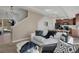 Bright open-concept living room with neutral tones and access to kitchen and dining areas at 17838 E 54 Th Ave, Denver, CO 80249