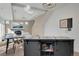 Kitchen and living room area features a movable island with storage, a modern fireplace, and a wall-mounted TV at 17838 E 54 Th Ave, Denver, CO 80249