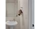 Elegant powder room features a pedestal sink, a decorative mirror, and modern fixtures at 17838 E 54 Th Ave, Denver, CO 80249