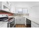 Well-equipped kitchen featuring granite countertops and white cabinets at 1035 Jasmine St # 3, Denver, CO 80220