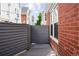 Private patio area with gray privacy fence at 1035 Jasmine St # 3, Denver, CO 80220