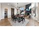 Open concept dining room with an overhead chandelier, which opens to both the living room and kitchen at 4174 Ridgewalk Pt, Castle Rock, CO 80108