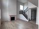 Bright living room with a fireplace and staircase with hardwood floors at 4174 Ridgewalk Pt, Castle Rock, CO 80108