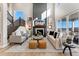 Inviting living room with soaring ceilings, fireplace, comfortable seating, and a flood of natural light at 4174 Ridgewalk Pt, Castle Rock, CO 80108