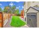 View of a fenced backyard with shed, mature trees and a patio area, perfect for outdoor living at 2316 Weatherstone Cir, Highlands Ranch, CO 80126