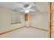 Basement with carpeted floor, ceiling fan, and natural light at 2316 Weatherstone Cir, Highlands Ranch, CO 80126